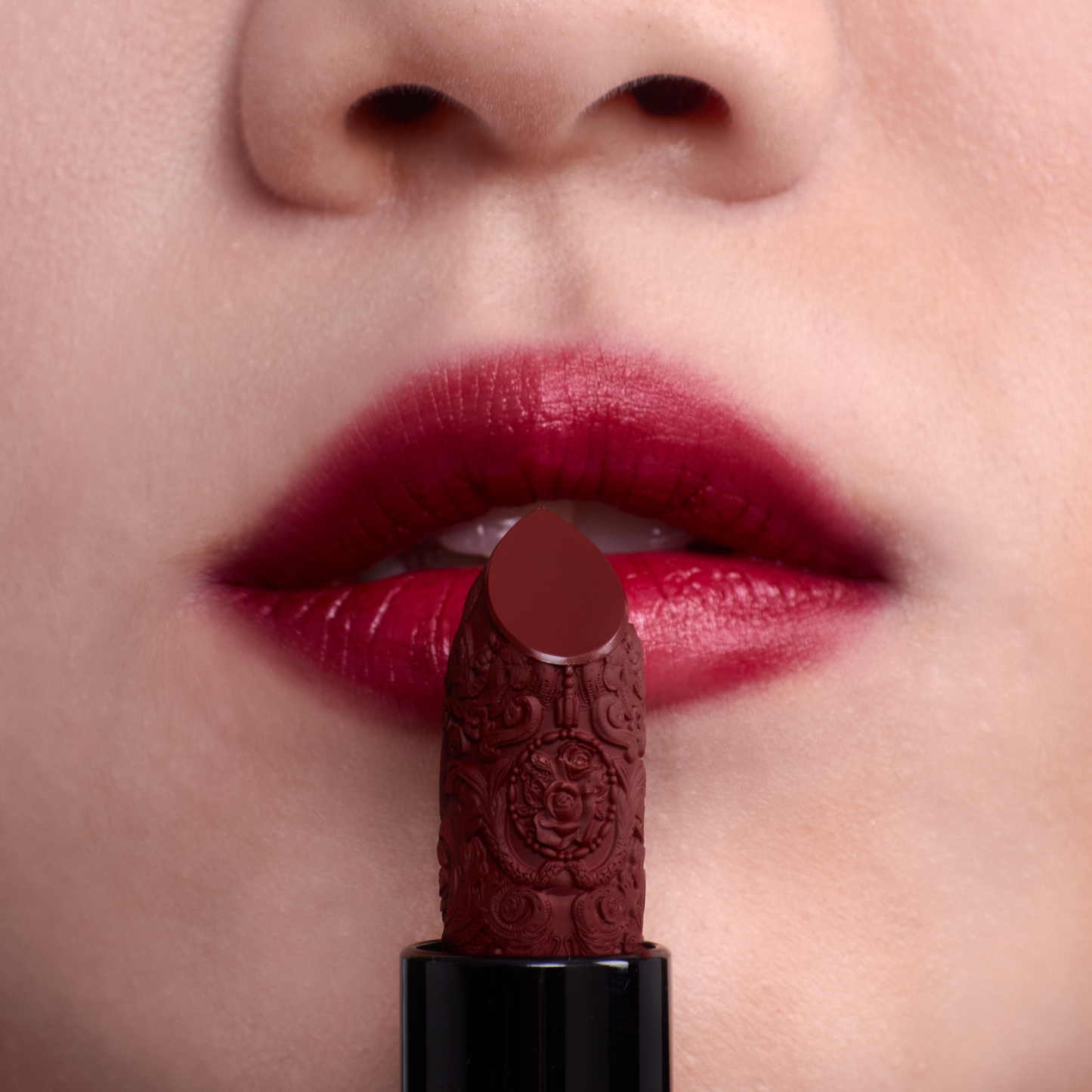 Deep red lipstick on the mouth of fair skin