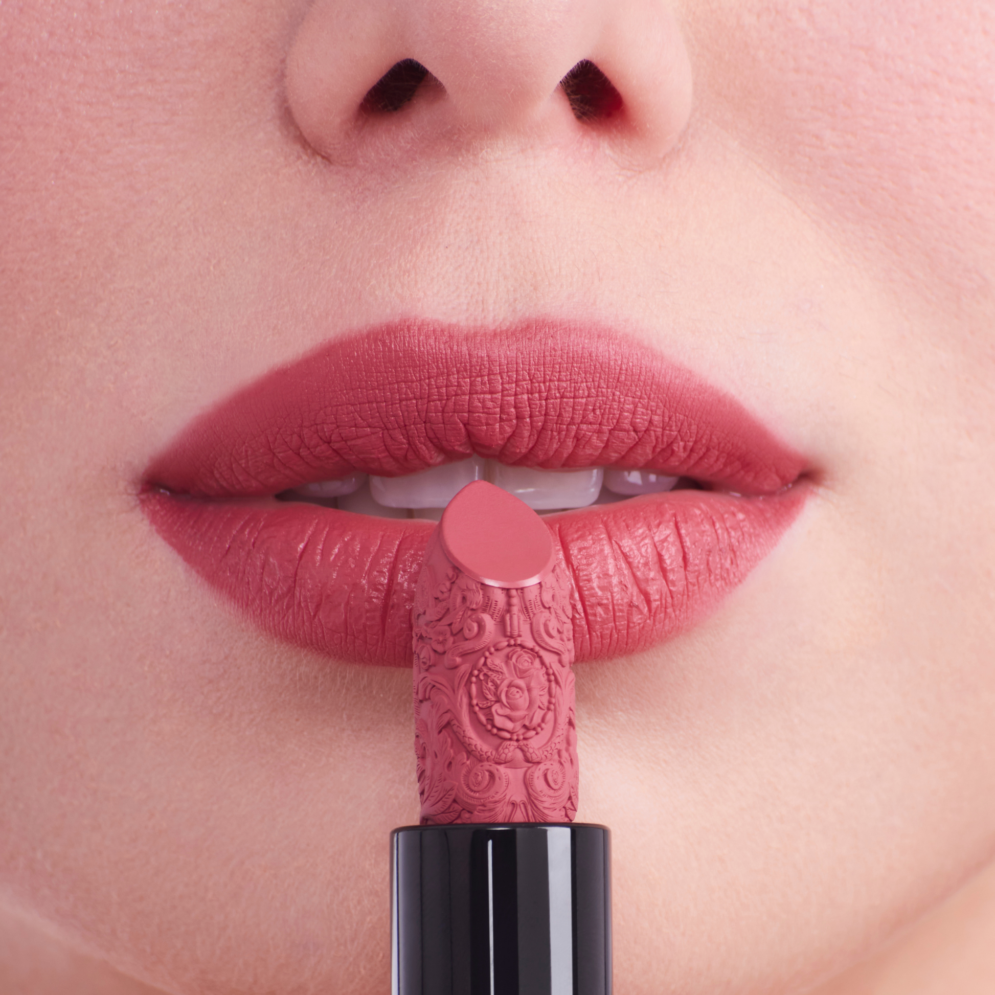 Nude pink carved lipstick on the mounth